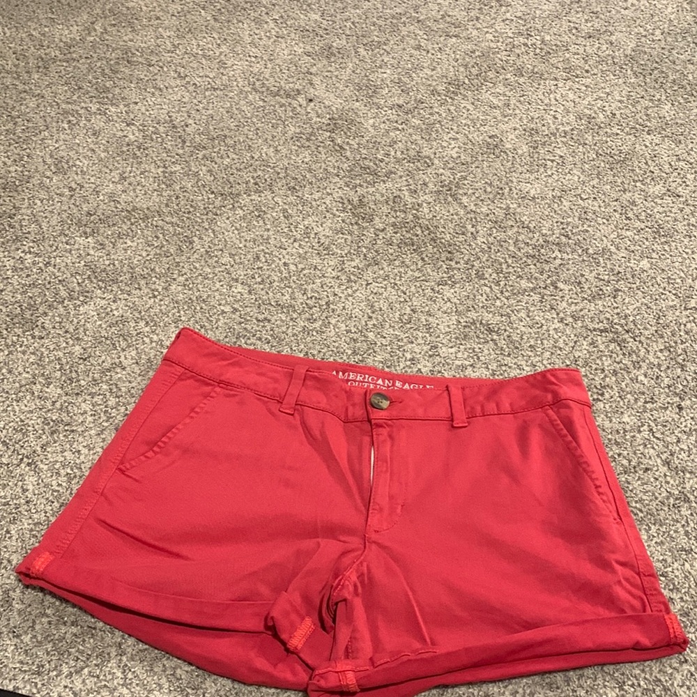 American eagle midi shorts in a muted red color